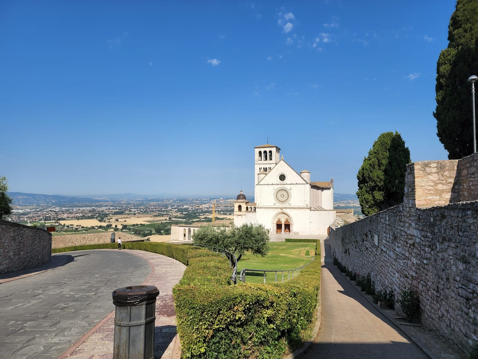 The Basilica of San Francesco in Assisi overlooking the Umbrian valley in morning light